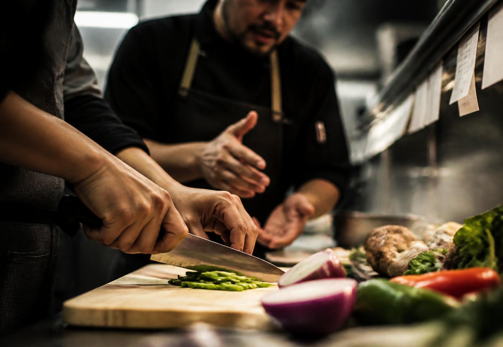 Trainees working a professional kitchen line
